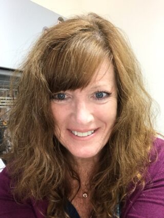 A girl with brown hair looking at camera